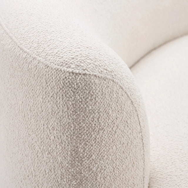 Detalle macro de la trama del tejido bouclé blanco crema del sofá Amaia